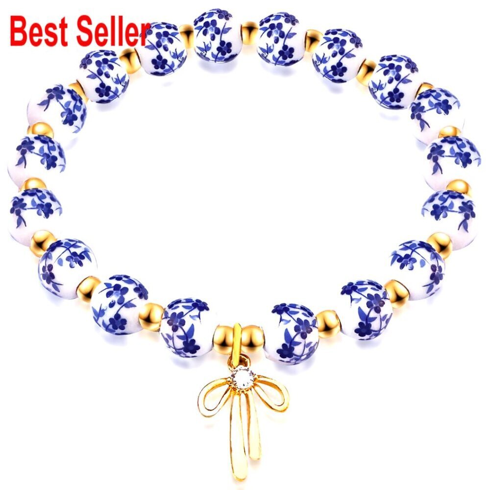 Gold Plated Stretch Bracelet with Bow Charm and Ceramic Beads